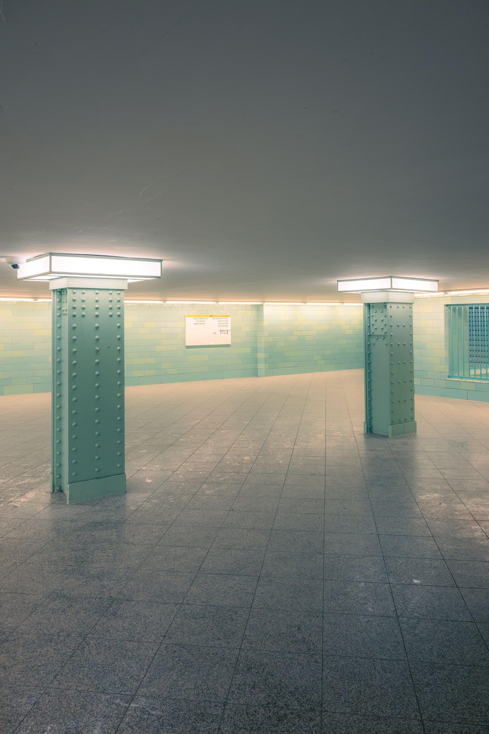 Minimal interior with structural columns and textured surfaces
